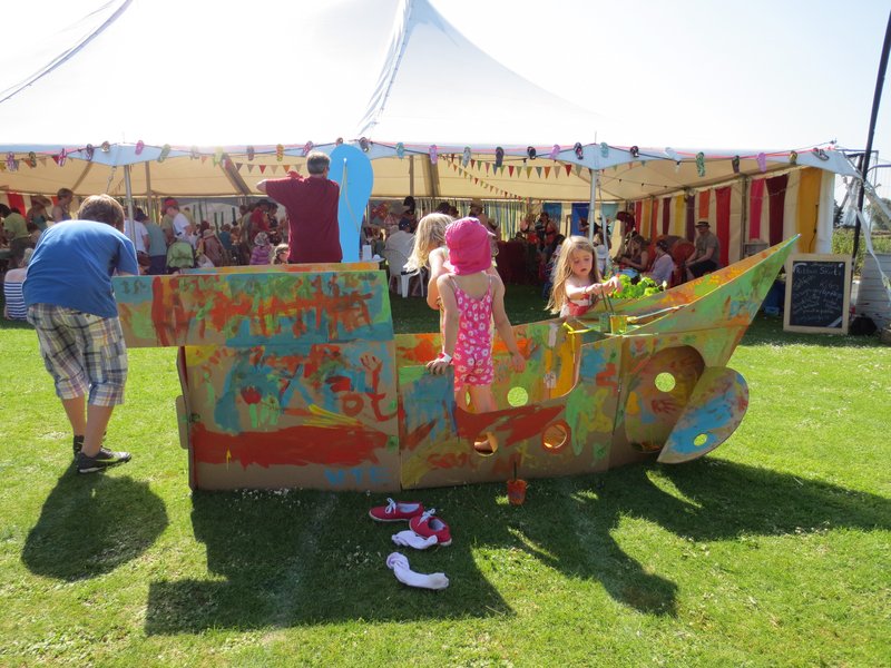 Painting a pirate ship in front of the Junkfish craft tent.